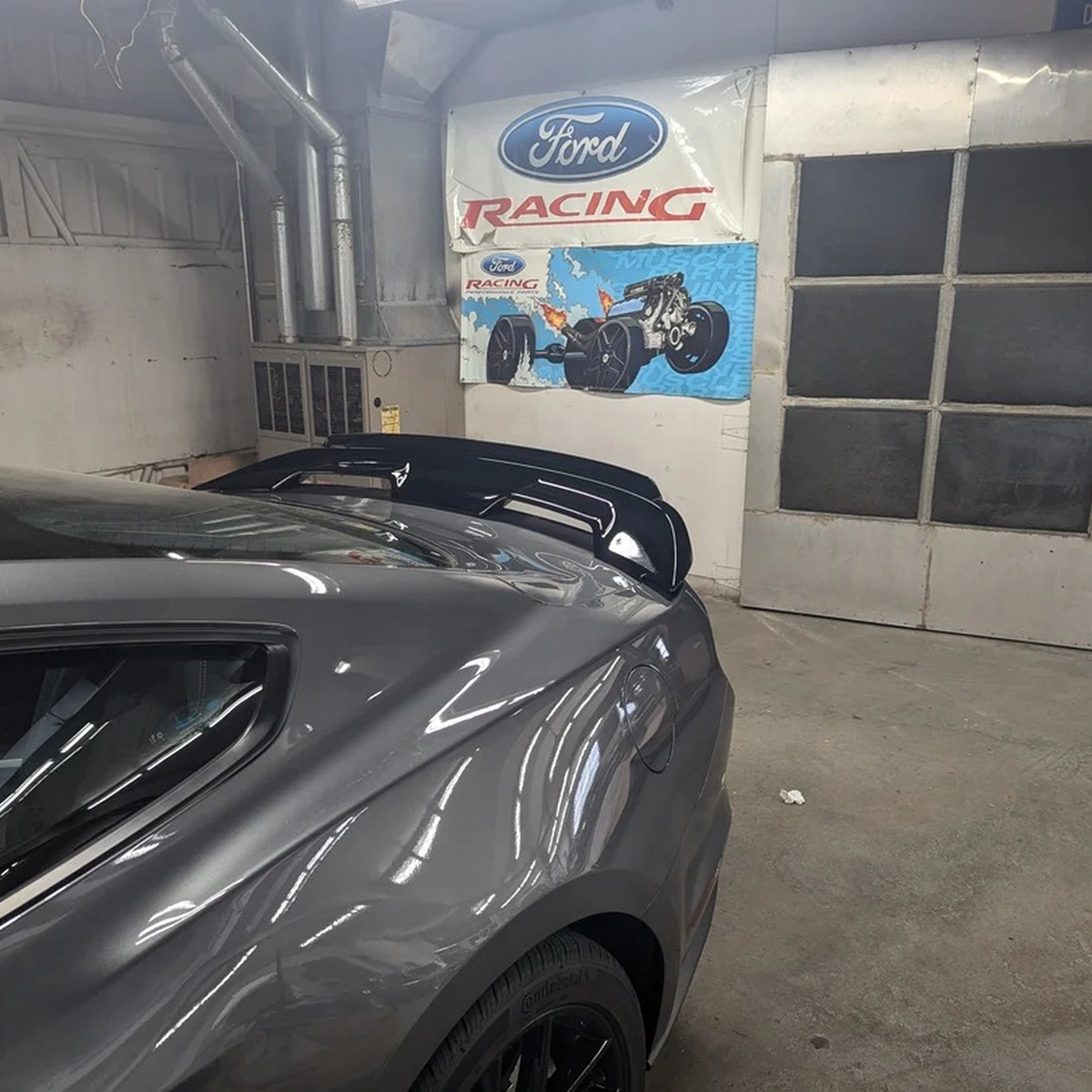 Ford Performance rear spoiler with gurney flap for 2015-2023 Mustang, featuring aerodynamic design and sleek styling.
