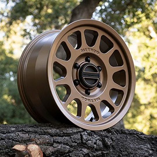 Five bronze Ford Performance Bronco 17-inch by 8.5-inch Method wheels with center caps, shown from a side angle.