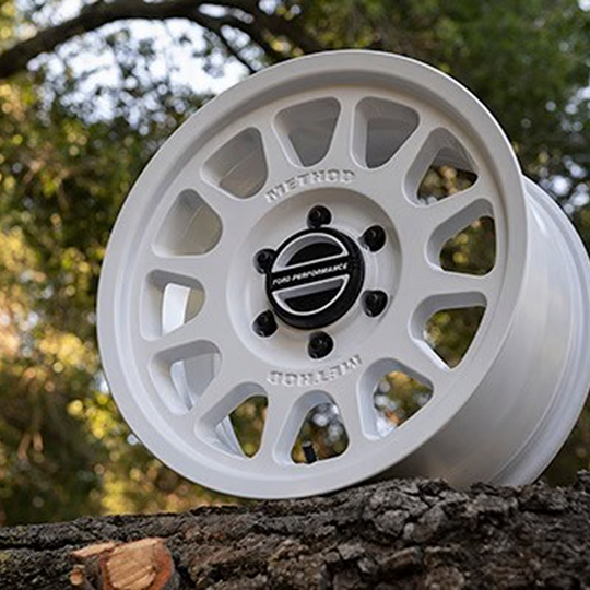 Set of five Ford Performance Bronco 17-inch by 8.5-inch white Method wheels with center caps, designed for off-road vehicles.