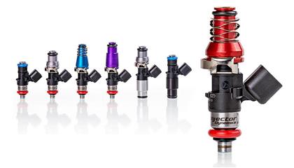 Injector Dynamics 1050X Ford fuel injectors, close-up of black metal injectors with wiring connectors for high-performance engine fueling